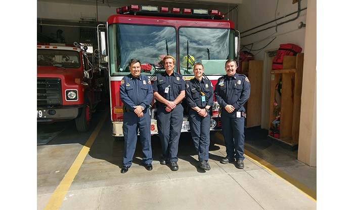 Firefighters standing in front of Station